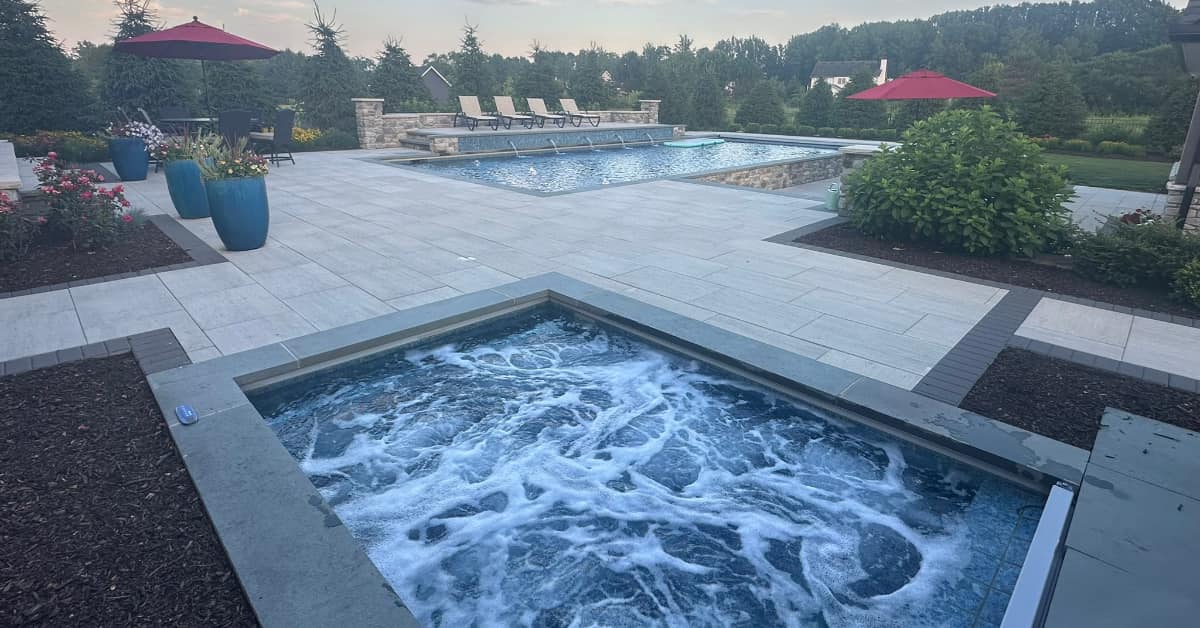 bubbly spa with pool in background, about us at Outside Design
